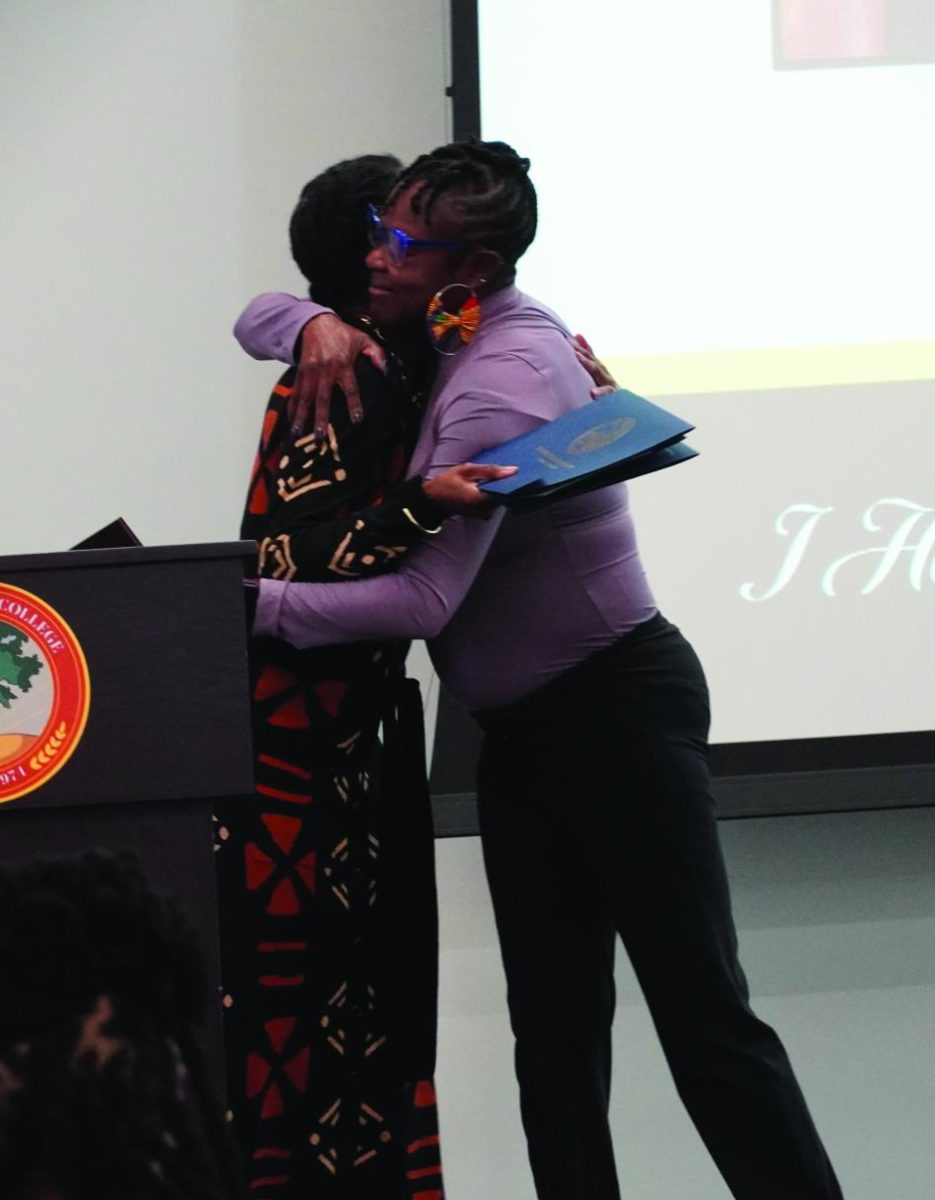 Visionary Leadership winner Dennisha Marsh hugs Vice President A'kilah Smith.