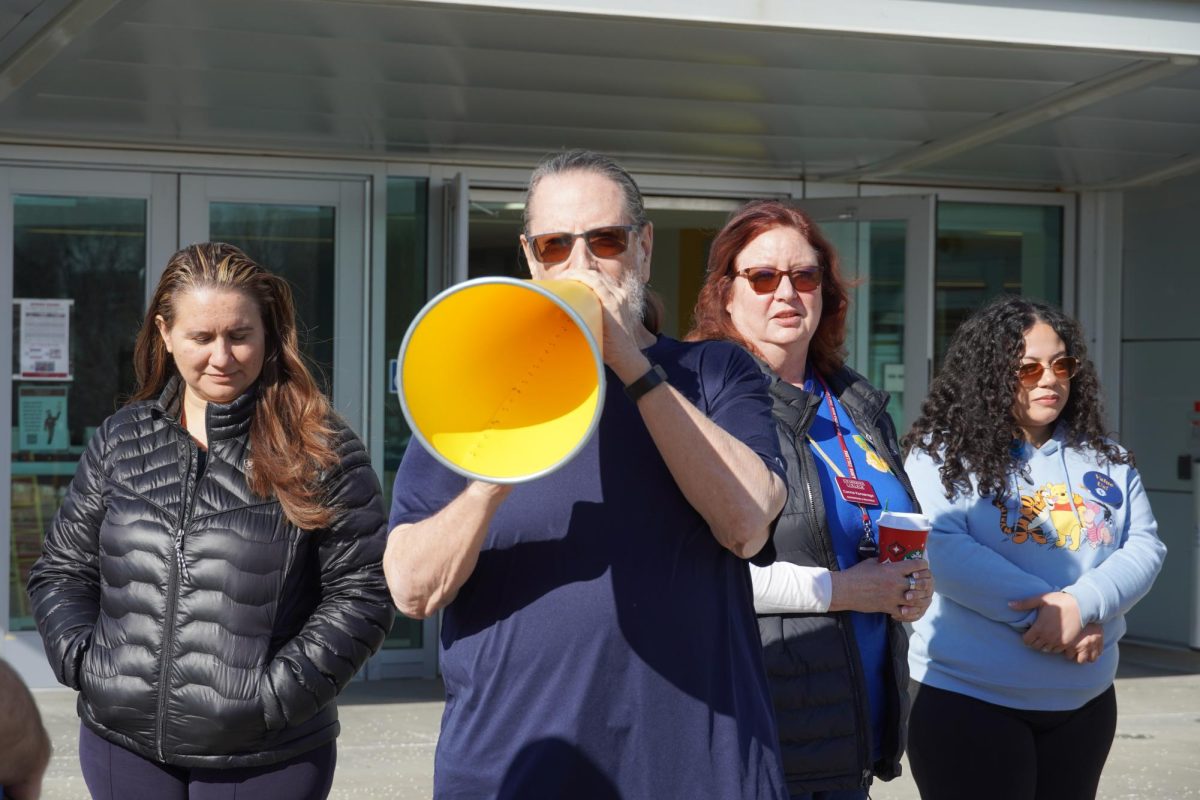 Professor Ken Alexander speaks at a solidarity event protesting the layoffs.