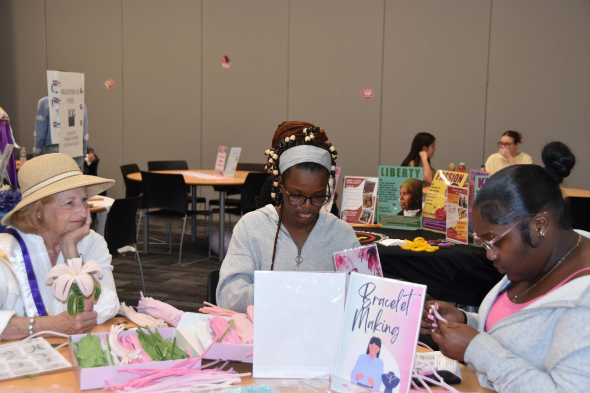 LMC Students Promise Anoruo and Shale Lakhan participate in the bead bracelet making table at the Women's History Month event coordinated by Student Life.