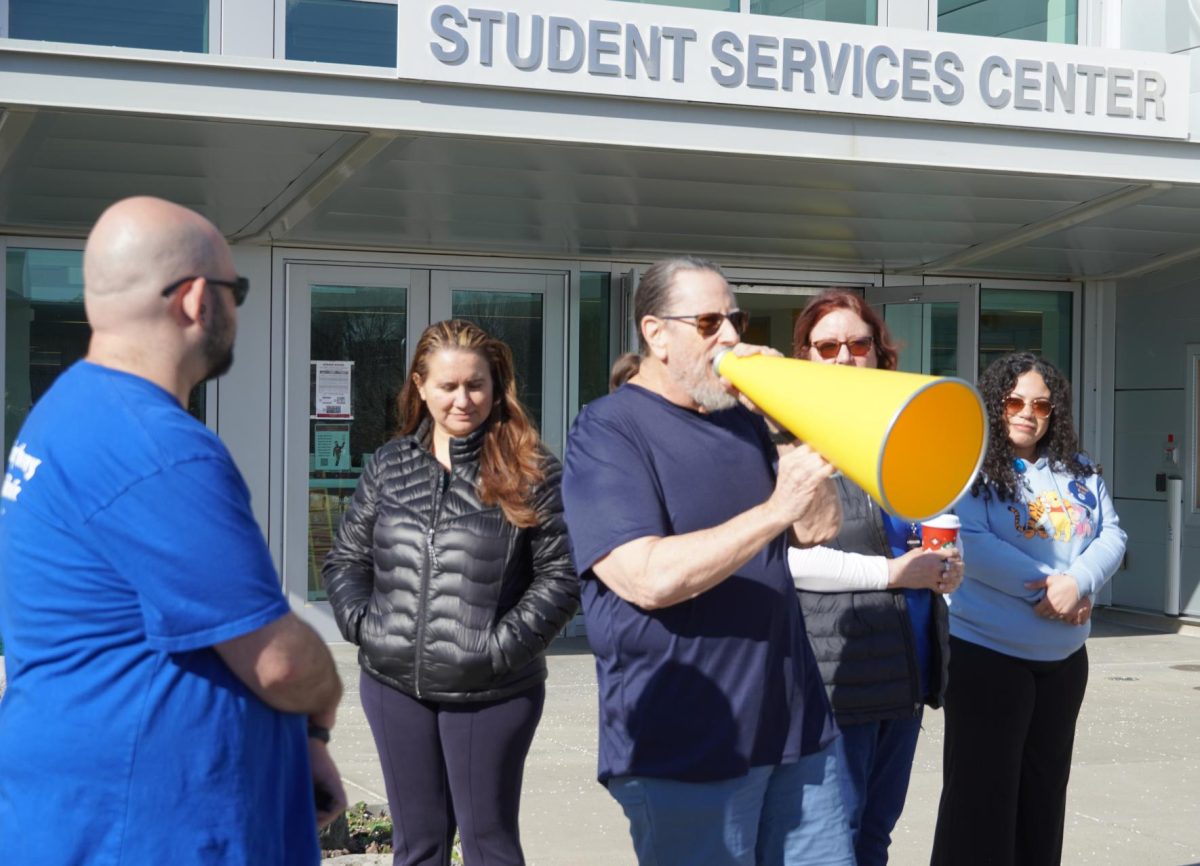Professor Ken Alexander speaks during a solidarity rally Tuesday, March 10, after layoffs were initially proposed. 