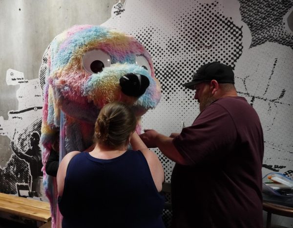 Costumer Nicole McGraw (left) with her husband (right) costumes the "Big Fluffy Monster" played by Isaac J. Kinney.