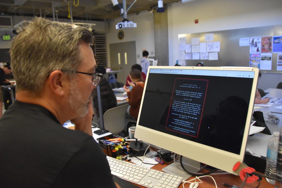 Los Medanos College art professor Eric Sanchez calls campus IT during his design drawing class as he reads the cyberattack message May 7.