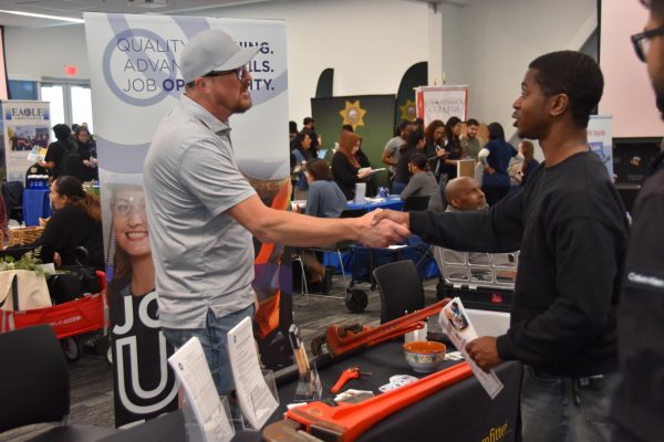 Attendee Vincent Raynor greets Robert Downs, Local 342 Plumbers, Steamfitters, Refrigeration and Pipeline union representative during the job fair held April 28.